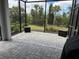 Covered screened-in patio with brick pavers and views of landscaped backyard at 2918 Butterfly Jasmine Trl, Sarasota, FL 34240