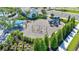 Aerial shot of a community playground featuring modern play equipment and a covered seating area at 2918 Butterfly Jasmine Trl, Sarasota, FL 34240