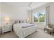 Bright bedroom with a large window, ceiling fan, and two bedside tables with lamps at 296 Treasure Boat Way, Sarasota, FL 34242