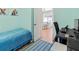 Bedroom with blue walls, a nearby study, and an open doorway at 296 Treasure Boat Way, Sarasota, FL 34242