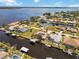 Wide aerial view displays a waterfront neighborhood, showcasing homes with canals and access to open water at 3069 Stone St, Port Charlotte, FL 33981
