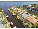 Aerial view of canal-front homes with boat lifts and docks, located near open water at 3069 Stone St, Port Charlotte, FL 33981