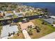 Waterfront home featuring a private dock, tile roof, mature palms and verdant landscaping at 3069 Stone St, Port Charlotte, FL 33981