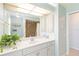 Well-lit bathroom with white cabinets, sink, and a tiled shower at 3069 Stone St, Port Charlotte, FL 33981