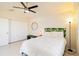 Bedroom features a bed with tropical headboard and a ceiling fan at 3069 Stone St, Port Charlotte, FL 33981