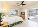 Bedroom boasts a white bed and sliding door to the pool at 3069 Stone St, Port Charlotte, FL 33981