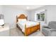 Bedroom with wood-framed bed, neutral colors, and a cozy sitting chair at 3069 Stone St, Port Charlotte, FL 33981