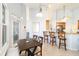 Bright dining area features a stylish table, chairs, and seamlessly connects to the breakfast bar and kitchen space at 3069 Stone St, Port Charlotte, FL 33981