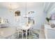 Open dining area bathed in light, featuring high ceilings and stylish decor at 3069 Stone St, Port Charlotte, FL 33981