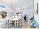 Bright dining area with white furniture, complemented by an island-themed rug at 3069 Stone St, Port Charlotte, FL 33981
