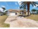 Inviting home with an attached garage, patterned driveway, lush lawn, and arched entryway at 3069 Stone St, Port Charlotte, FL 33981
