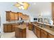 Open kitchen design with island, stainless steel appliances, and a view overlooking the living area and outdoor spaces at 3069 Stone St, Port Charlotte, FL 33981