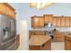 Well-equipped kitchen boasts stainless steel appliances, wooden cabinets, and a convenient center island for meal preparation at 3069 Stone St, Port Charlotte, FL 33981