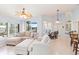 Spacious living room boasts a large sectional couch, water views, and seamless transition to the kitchen and dining area at 3069 Stone St, Port Charlotte, FL 33981