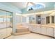 Luxury bathroom with large vanity, glass block window, and soaking tub at 3069 Stone St, Port Charlotte, FL 33981