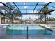 The in-ground pool has a screen enclosure with a view of the canal at 3069 Stone St, Port Charlotte, FL 33981