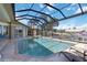 An in-ground pool is enclosed within a screen and is adjacent to the canal at 3069 Stone St, Port Charlotte, FL 33981