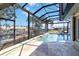 A screened-in pool offers views of the canal at 3069 Stone St, Port Charlotte, FL 33981