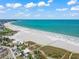 An aerial view of the beach shows the beautiful white sands and turquoise waters of Siesta Key at 336 Avenida De Mayo, Sarasota, FL 34242