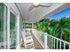 Spacious balcony with rocking chairs, palm trees, and a ceiling fan at 336 Avenida De Mayo, Sarasota, FL 34242