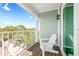 Relaxing balcony with a white wooden Adirondack chair and decorative metal chair at 336 Avenida De Mayo, Sarasota, FL 34242