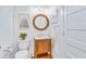 Neat half bathroom with wood cabinet sink, framed art, and classic fixtures perfect for guests at 336 Avenida De Mayo, Sarasota, FL 34242