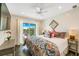 Cozy bedroom features a ceiling fan, balcony access, and a serene atmosphere at 336 Avenida De Mayo, Sarasota, FL 34242