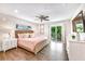 Bright bedroom with hardwood floors, balcony access, and comfortable furnishings at 336 Avenida De Mayo, Sarasota, FL 34242