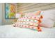 Bedroom decor detail shot of a bed with a vibrant decorative pillow and artwork on the wall at 336 Avenida De Mayo, Sarasota, FL 34242