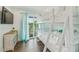 Bright bunk room featuring hardwood floors, large window and walk-out access to a balcony at 336 Avenida De Mayo, Sarasota, FL 34242