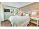 Comfortable bedroom featuring a wood accent wall, a large window, and a TV at 336 Avenida De Mayo, Sarasota, FL 34242