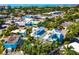 Aerial view of a lush tropical condo community with a pool and ocean views at 336 Avenida De Mayo, Sarasota, FL 34242