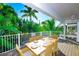 Inviting deck with dining table set for six overlooking lush landscaping at 336 Avenida De Mayo, Sarasota, FL 34242