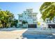 A three-story, light blue home with a dark brown garage door and multiple balconies at 336 Avenida De Mayo, Sarasota, FL 34242