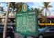 St. Armands Circle historical marker sign, with a view of shops and palm trees in the background at 336 Avenida De Mayo, Sarasota, FL 34242