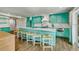 Bright kitchen with turquoise cabinetry, a large island, and modern appliances, ideal for entertaining at 336 Avenida De Mayo, Sarasota, FL 34242