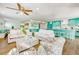 Inviting living room with ample seating and colorful decor, adjacent to a vibrant, turquoise kitchen at 336 Avenida De Mayo, Sarasota, FL 34242