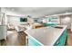 Open-concept living area with modern kitchen, island seating, and comfortable furnishings at 336 Avenida De Mayo, Sarasota, FL 34242