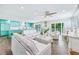 Living room with view of the kitchen, bright interiors, hardwood floors, and sliding glass doors at 336 Avenida De Mayo, Sarasota, FL 34242