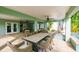 Beautiful outdoor dining area with table and chairs, covered patio, and swimming pool access at 336 Avenida De Mayo, Sarasota, FL 34242
