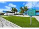 Beautiful image of Siesta Beach with lush green grass and palm trees and building in the background at 336 Avenida De Mayo, Sarasota, FL 34242
