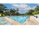 Community pool offers residents a refreshing escape, complete with lounge chairs and shade umbrellas at 3424 Hadfield Greene # 17, Sarasota, FL 34235
