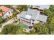 Aerial view of house showcasing private pool, patio and lush surroundings with a metal roof at 3455 Flamingo Ave, Sarasota, FL 34242