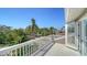 Balcony view featuring lush tropical landscaping, a neighborhood street, and blue skies at 3455 Flamingo Ave, Sarasota, FL 34242
