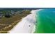 A breathtaking aerial view of a stunning white sand beach with turquoise waters at 3455 Flamingo Ave, Sarasota, FL 34242