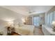 Cozy bedroom with ample natural light, hardwood floors, wicker wardrobe and soft furnishings at 3455 Flamingo Ave, Sarasota, FL 34242