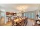 Elegant dining room featuring a chandelier, wood table set for eight and access to a kitchen bar at 3455 Flamingo Ave, Sarasota, FL 34242