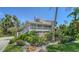 Charming two-story home featuring a spacious porch and lush landscaping with tropical accents at 3455 Flamingo Ave, Sarasota, FL 34242