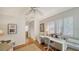 Bright home office with white desk, ample natural light, hardwood floors and access to closets at 3455 Flamingo Ave, Sarasota, FL 34242