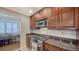 Well-equipped kitchen with stainless steel appliances, granite countertop and cherry wood cabinetry at 3455 Flamingo Ave, Sarasota, FL 34242
